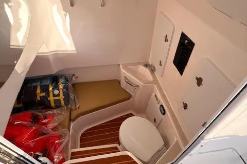 Johnny B' Good Yacht Photos Pics 2015 Edgewater 280CC boat interior with toilet and storage area.
