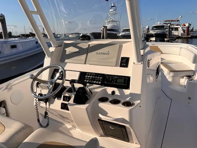 Johnny B' Good Yacht Photos Pics 2015 Edgewater 280CC boat cockpit with Garmin navigation system and steering wheel.