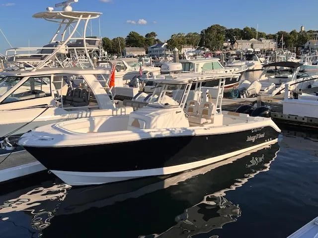 Johnny B' Good Yacht Photos Pics 2015 Edgewater 280CC boat docked in a marina, surrounded by other vessels.