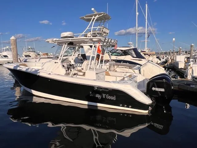 Johnny B' Good Yacht Photos Pics 2015 Edgewater 280CC boat docked in marina, sunny day, clear sky.