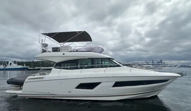 R & R Yacht Photos Pics Luxury 2015 Prestige 420 yacht on calm water under cloudy skies.
