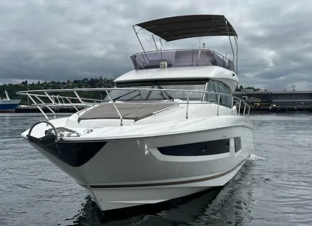 R & R Yacht Photos Pics Luxury 2015 Prestige 420 yacht on calm water under cloudy sky.