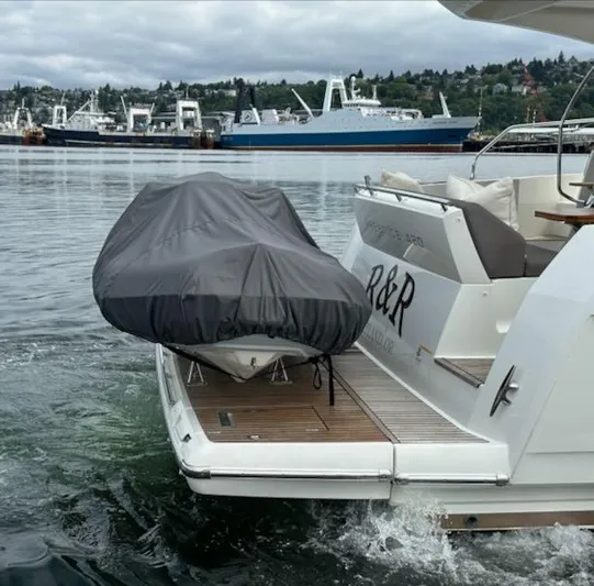 R & R Yacht Photos Pics Prestige 420 yacht, 2015 model, with covered dinghy on deck, docked in a marina.