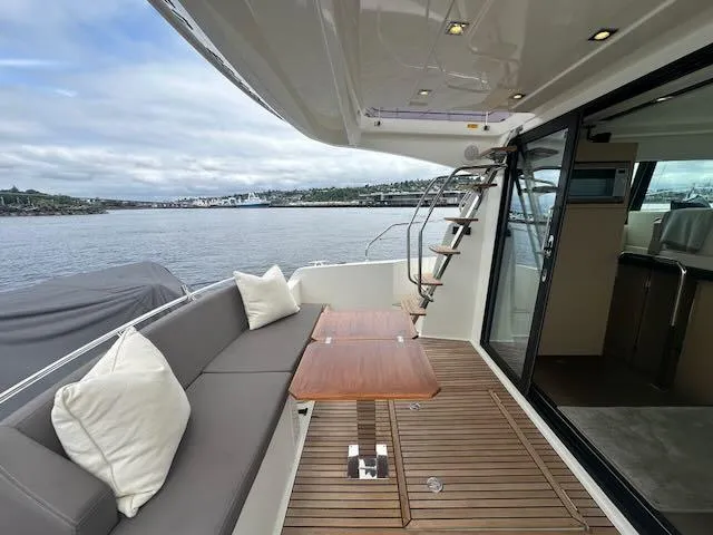 R & R Yacht Photos Pics Luxury 2015 Prestige 420 yacht with elegant deck seating and scenic water view.