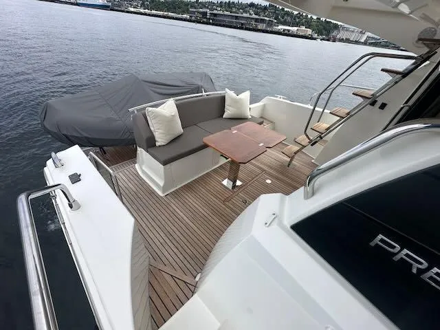 R & R Yacht Photos Pics Luxury 2015 Prestige 420 yacht with elegant deck seating and scenic waterfront view.