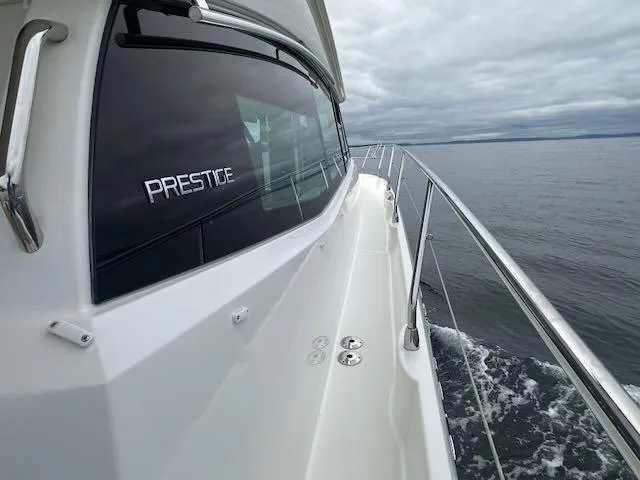 R & R Yacht Photos Pics Prestige 420 yacht cruising on open water under cloudy skies, 2015 model.