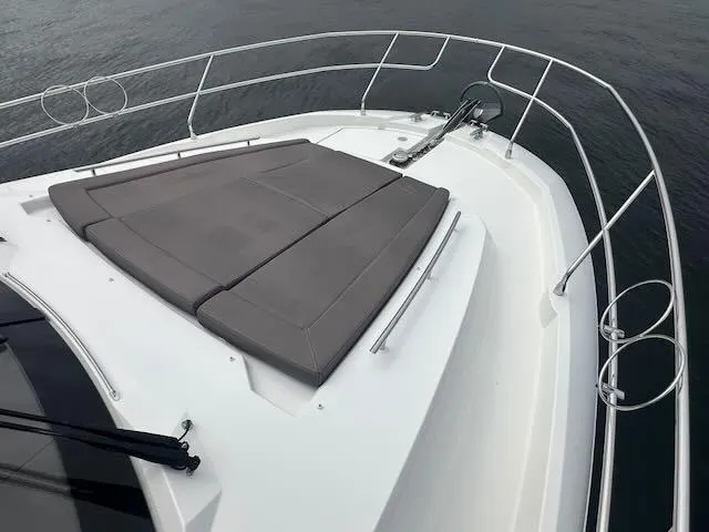 R & R Yacht Photos Pics Prestige 420 yacht bow with cushioned sunbed, 2015 model, on calm water.