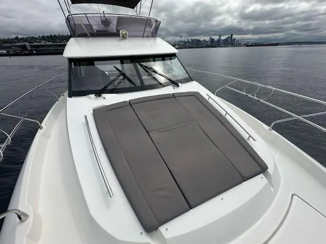 R & R Yacht Photos Pics Prestige 420 yacht, 2015 model, with sun pad on deck, city skyline in background.
