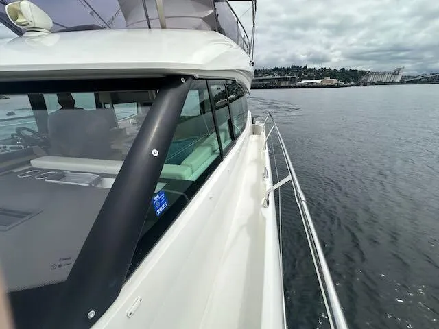 R & R Yacht Photos Pics Prestige 420 yacht cruising on calm waters, 2015 model, with scenic shoreline view.