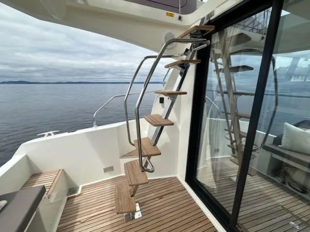 R & R Yacht Photos Pics Staircase on 2015 Prestige 420 yacht with ocean view and wooden deck.