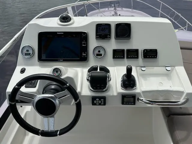 R & R Yacht Photos Pics Cockpit of 2015 Prestige 420 yacht with steering wheel and navigation controls.