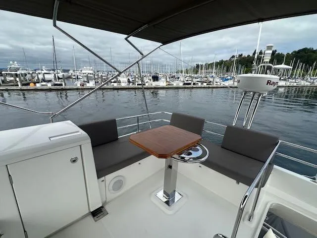 R & R Yacht Photos Pics Prestige 420 yacht deck with seating and table, docked at marina, 2015 model.