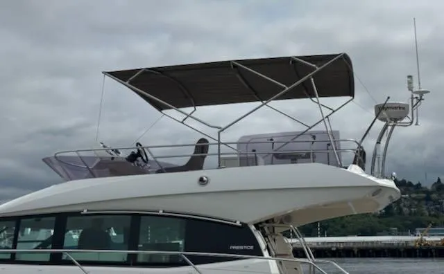 R & R Yacht Photos Pics 2015 Prestige 420 yacht with canopy, docked under cloudy skies.