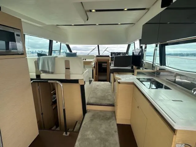 R & R Yacht Photos Pics Luxurious interior of a 2015 Prestige 420 yacht with modern kitchen and seating area.