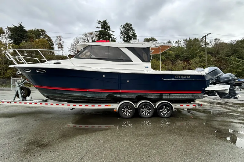  Yacht Photos Pics 2019 Cutwater C-302 Coupe boat on trailer, parked outdoors on a cloudy day.