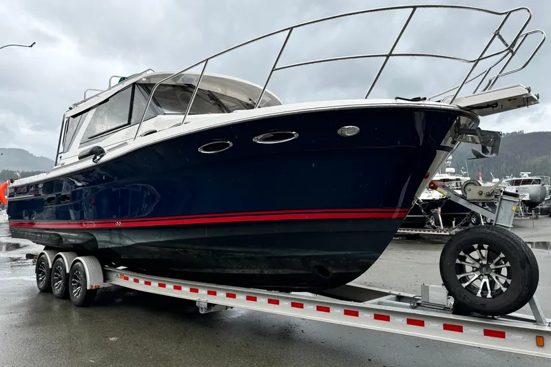  Yacht Photos Pics 2019 Cutwater C-302 Coupe boat on trailer, sleek design, parked outdoors.