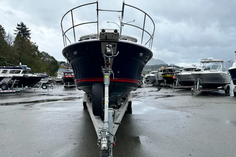  Yacht Photos Pics 2019 Cutwater C-302 Coupe on trailer in a boatyard under cloudy skies.