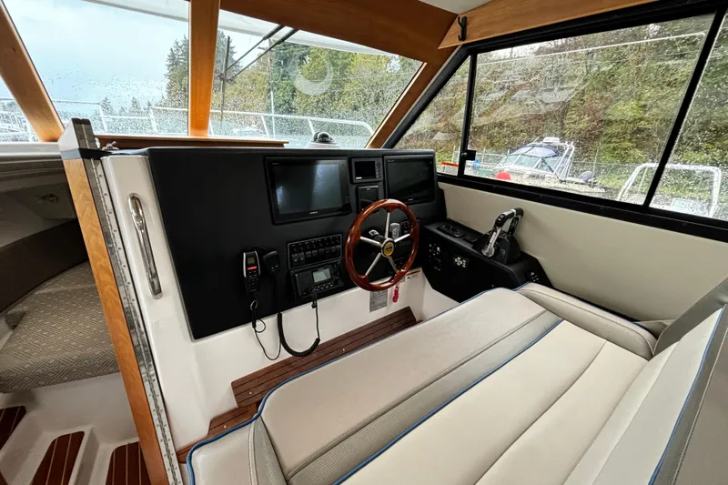  Yacht Photos Pics 2019 Cutwater C-302 Coupe helm with modern controls and comfortable seating.
