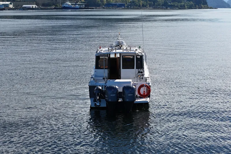  Yacht Photos Pics 2019 Cutwater C-302 Coupe boat on calm water, rear view with dual engines.