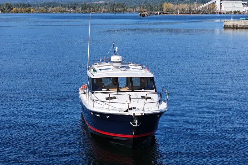  Yacht Photos Pics 2019 Cutwater C-302 Coupe boat on calm blue water, scenic background.