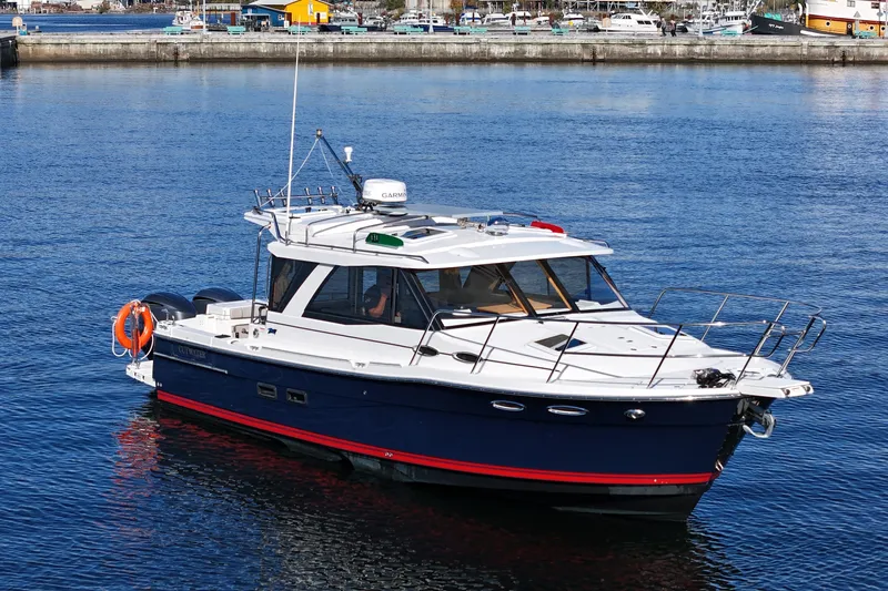  Yacht Photos Pics 2019 Cutwater C-302 Coupe boat on calm water near a marina.