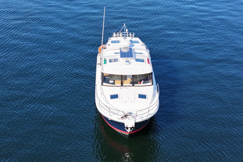  Yacht Photos Pics 2019 Cutwater C-302 Coupe boat on calm blue water, aerial view.