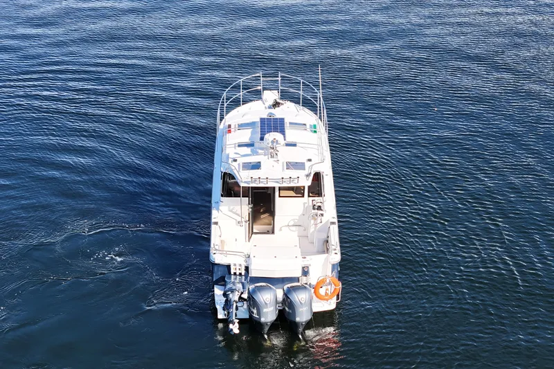  Yacht Photos Pics 2019 Cutwater C-302 Coupe boat on open water, rear view.