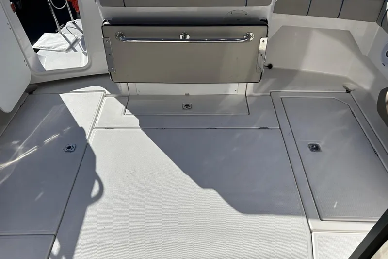  Yacht Photos Pics 2019 Cutwater C-302 Coupe boat deck with storage compartments and foldable seat.