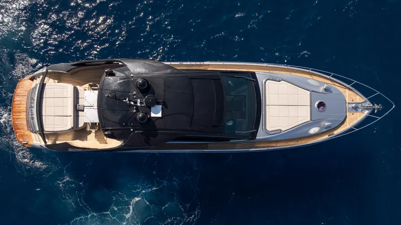 "liquid" Yacht Photos Pics Top view of a 2020 Pershing 70 yacht cruising on deep blue ocean waters.