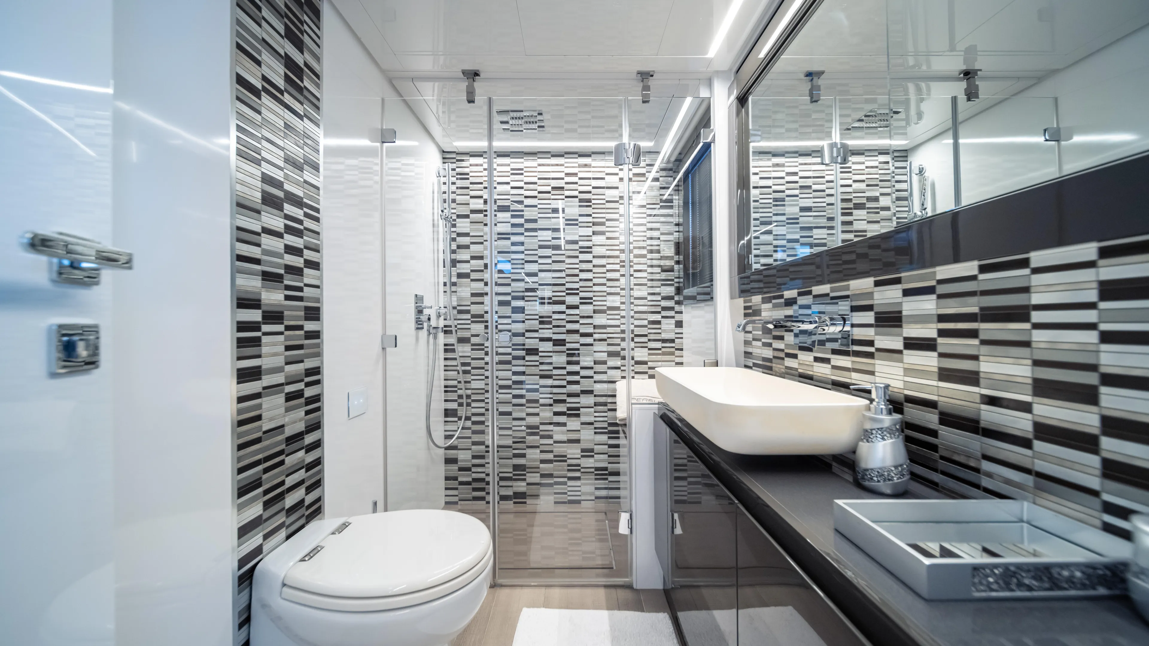 "liquid" Yacht Photos Pics Luxurious bathroom in 2020 Pershing 70 yacht with modern design and sleek fixtures.