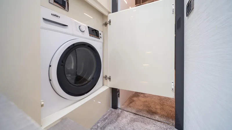 "liquid" Yacht Photos Pics Laundry area with a washing machine inside a 2020 Pershing 70 yacht.