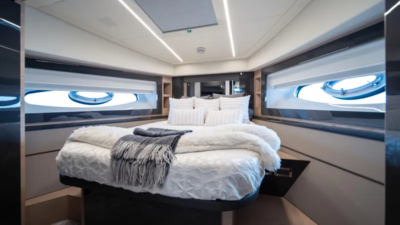 "liquid" Yacht Photos Pics Luxurious bedroom interior of 2020 Pershing 70 yacht with modern design and cozy bedding.