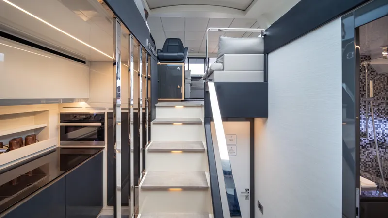 "liquid" Yacht Photos Pics Luxurious interior of 2020 Pershing 70 yacht with modern staircase and sleek design elements.