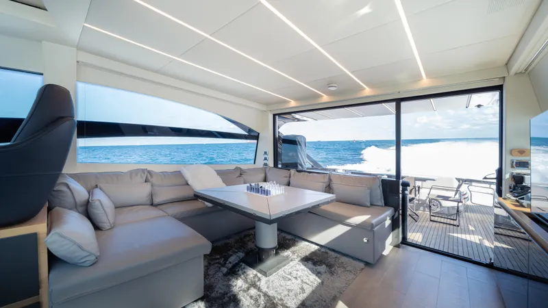 "liquid" Yacht Photos Pics Luxurious interior of 2020 Pershing 70 yacht with ocean view and modern seating area.