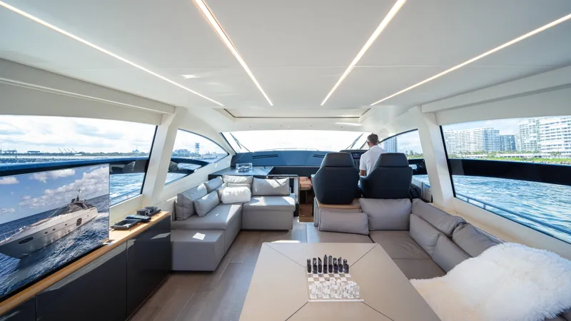 "liquid" Yacht Photos Pics Luxurious interior of a 2020 Pershing 70 yacht with modern seating and panoramic windows.