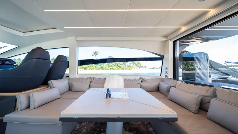 "liquid" Yacht Photos Pics Luxurious interior of a 2020 Pershing 70 yacht with plush seating and scenic views.