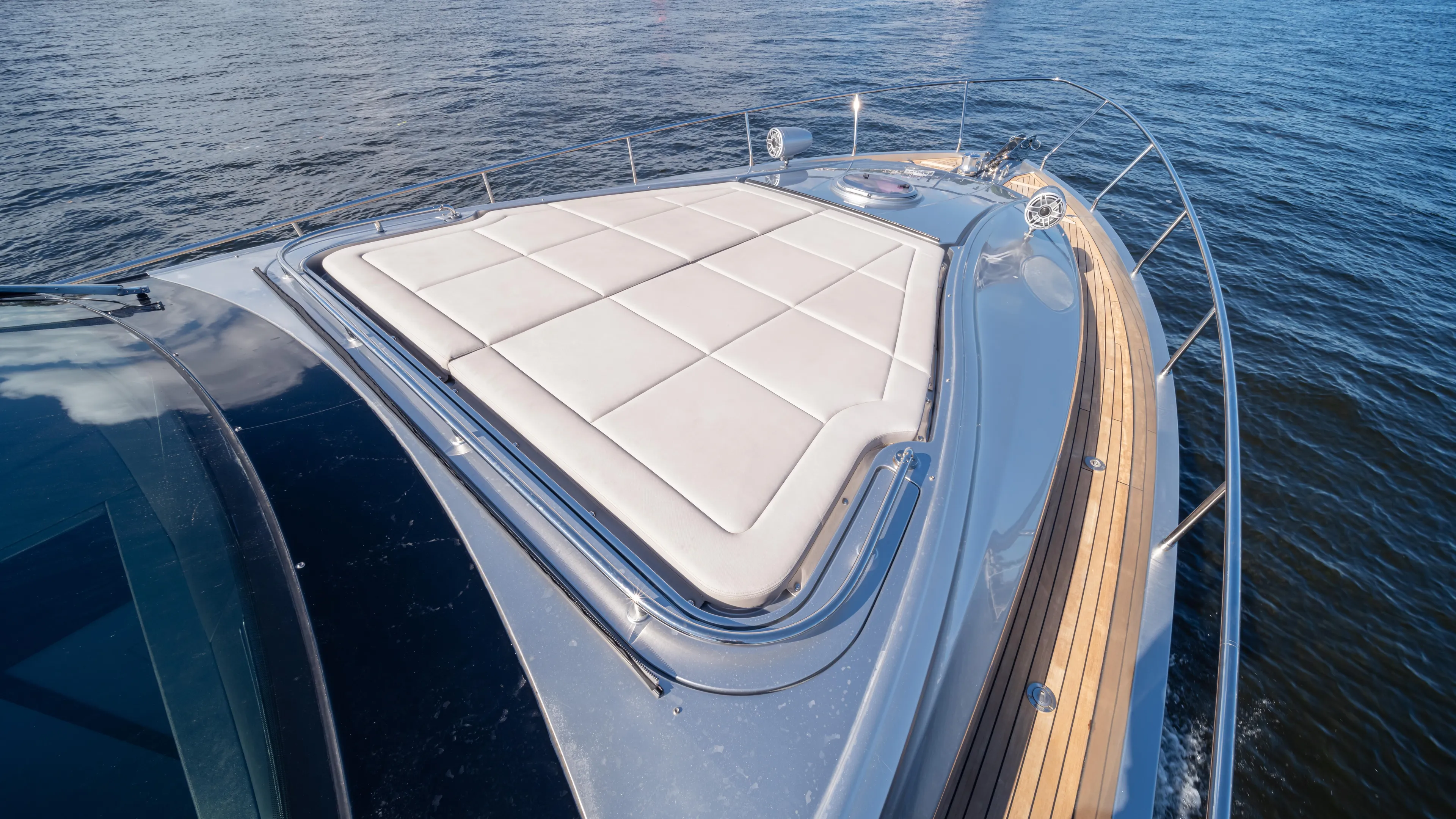 "liquid" Yacht Photos Pics 2020 Pershing 70 yacht deck with sunpad, cruising on open water.
