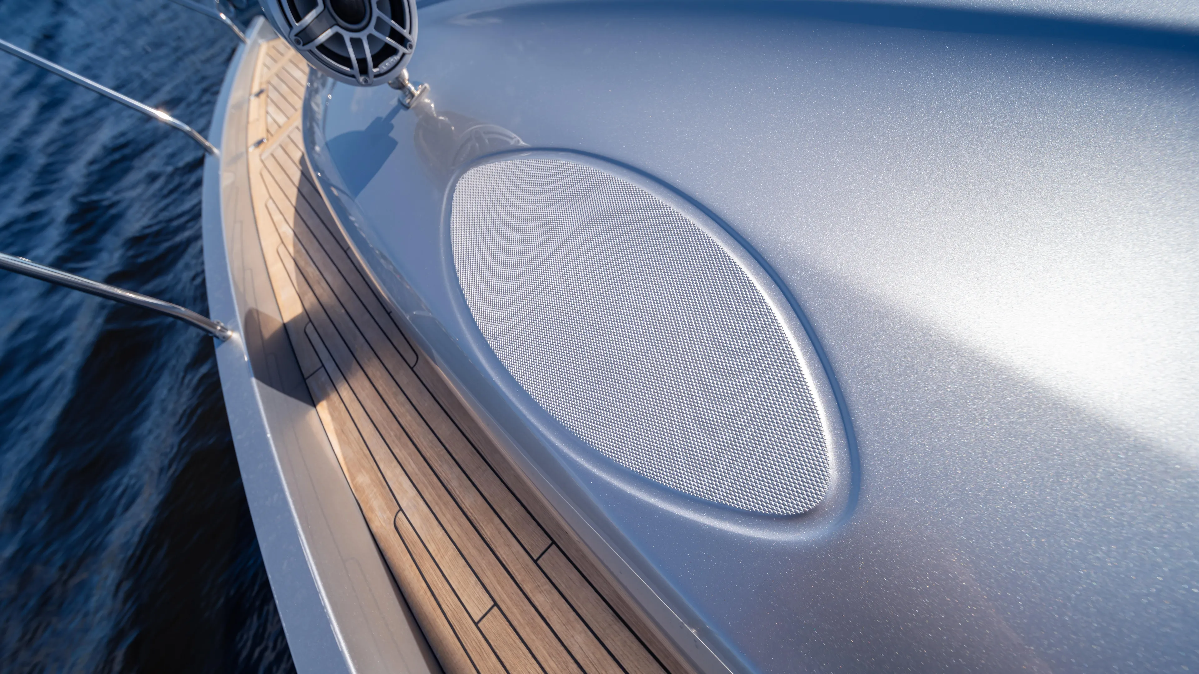 "liquid" Yacht Photos Pics Close-up of 2020 Pershing 70 yacht deck with sleek metallic finish and wooden flooring.