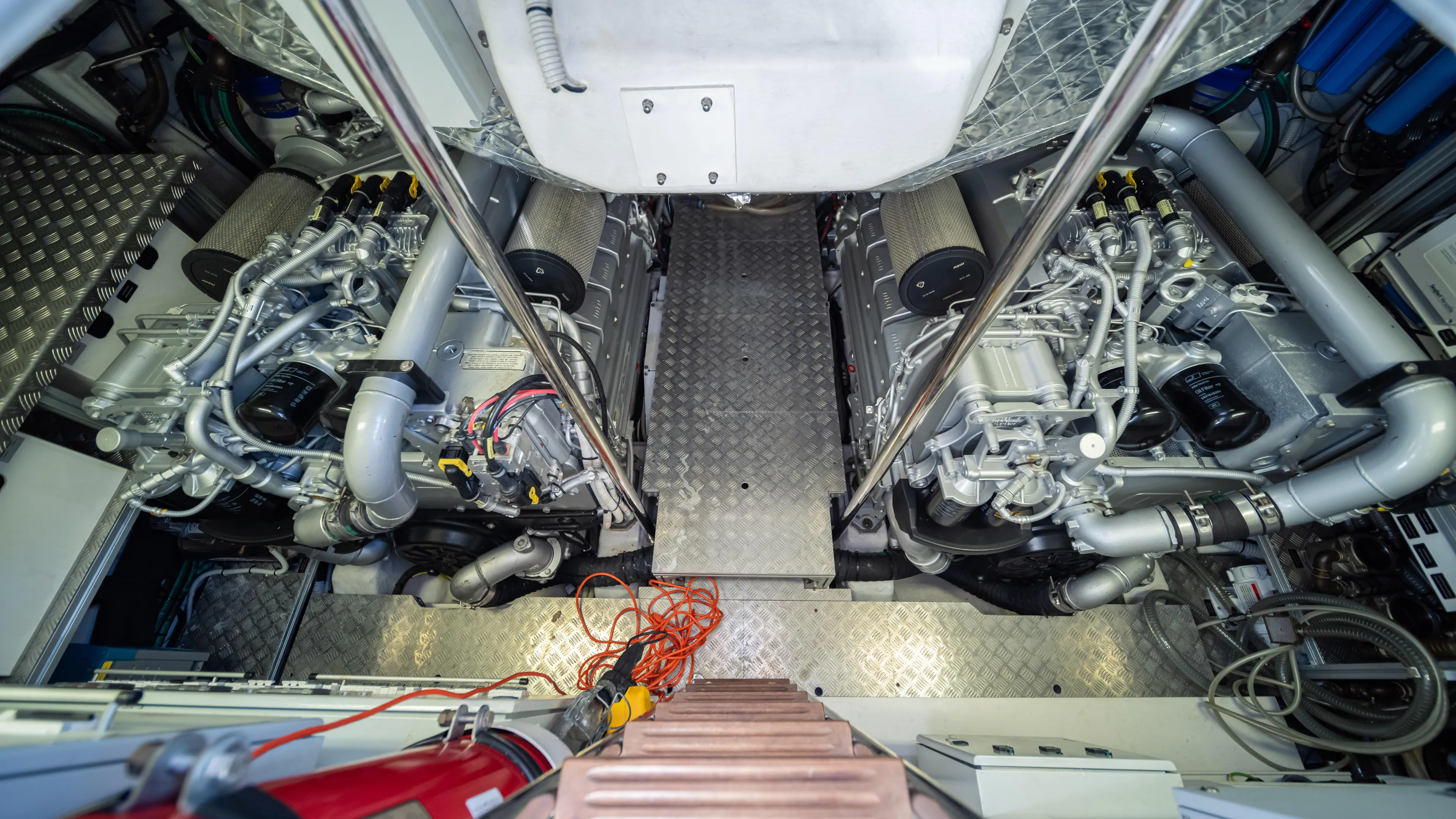 "liquid" Yacht Photos Pics Engine room of a 2020 Pershing 70 yacht, showcasing dual engines and mechanical components.