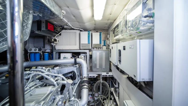 "liquid" Yacht Photos Pics Engine room of a 2020 Pershing 70 yacht, showcasing advanced machinery and equipment.