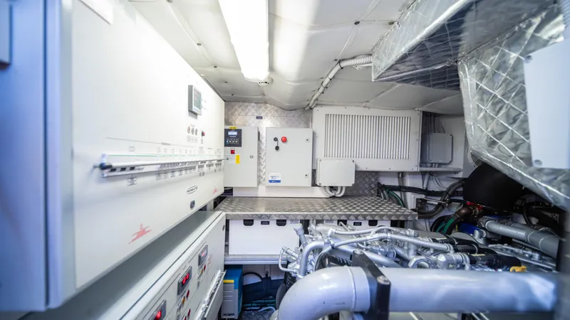 "liquid" Yacht Photos Pics Engine room of a 2020 Pershing 70 yacht, featuring advanced machinery and control panels.