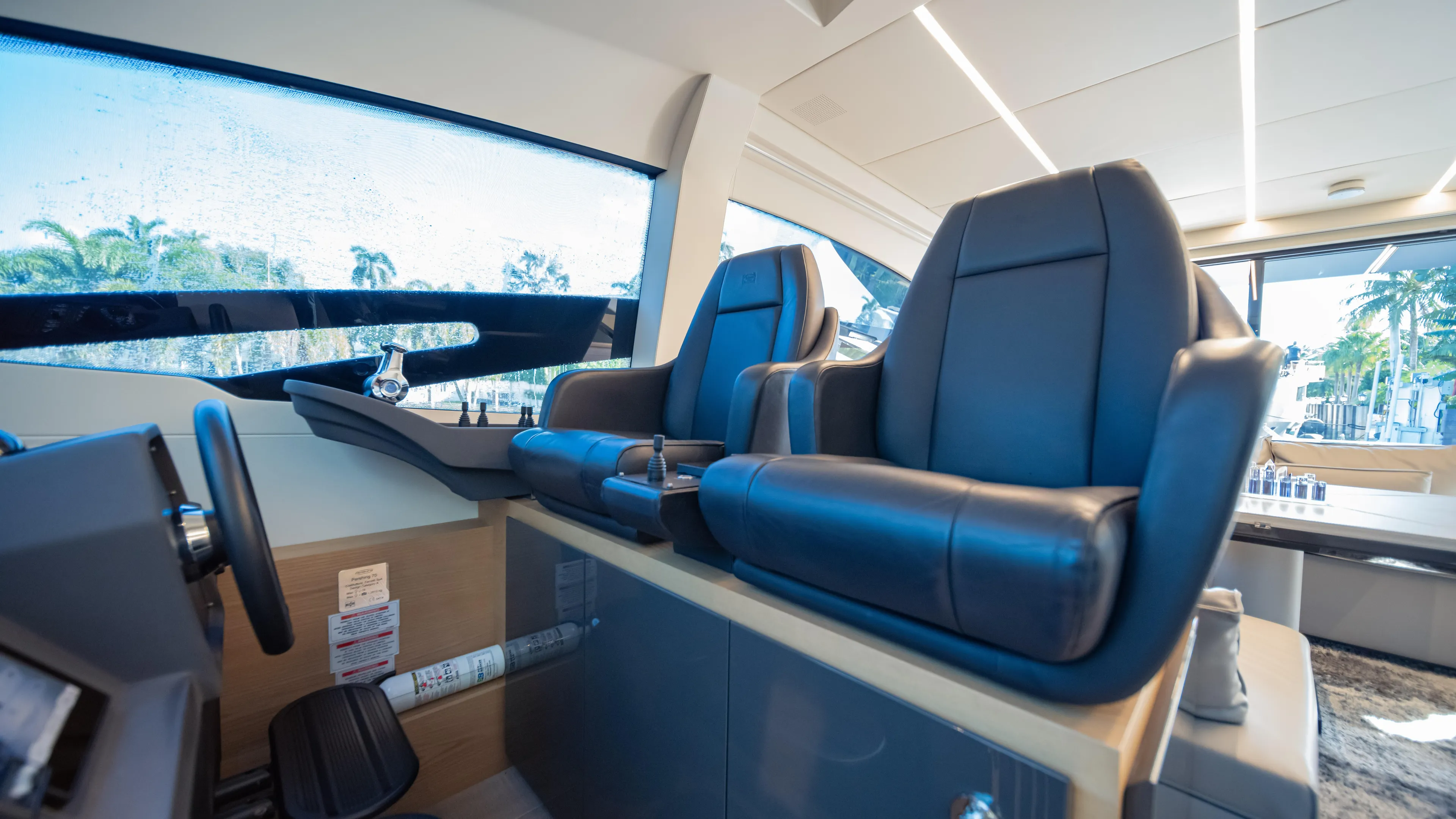 "liquid" Yacht Photos Pics Luxurious interior of a 2020 Pershing 70 yacht with sleek black leather seats.