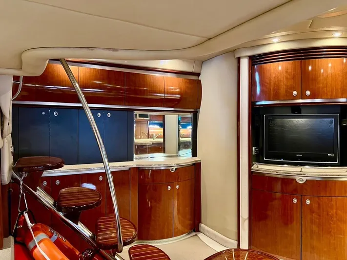  Yacht Photos Pics Interior of 2004 Sea Ray 500 Sundancer yacht with wooden cabinetry and TV.