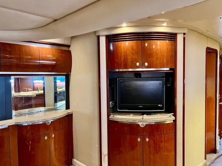  Yacht Photos Pics Luxurious interior of a 2004 Sea Ray 500 Sundancer yacht with wood cabinetry and TV.