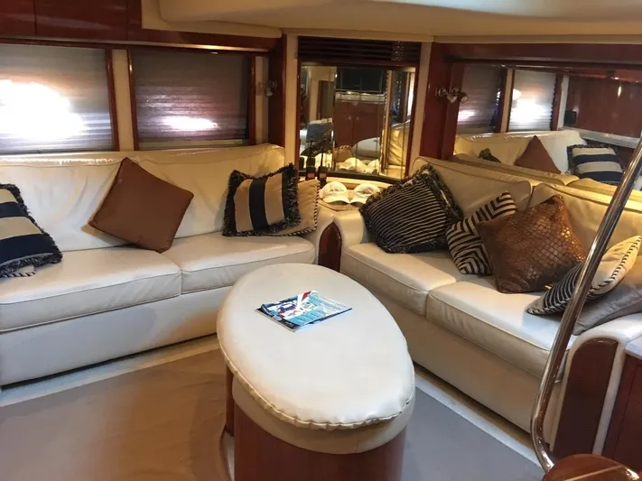  Yacht Photos Pics Luxurious interior of 2004 Sea Ray 500 Sundancer with white leather seating and decorative pillows.