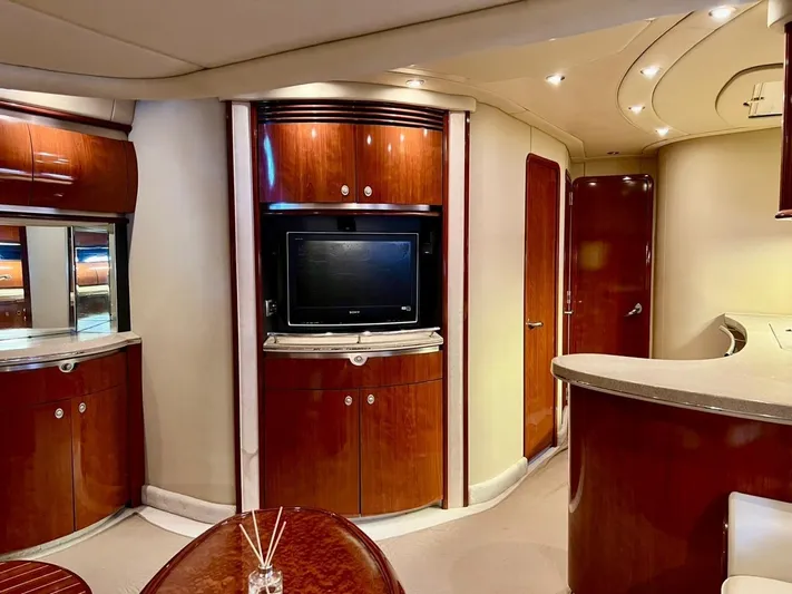  Yacht Photos Pics Luxurious interior of a 2004 Sea Ray 500 Sundancer yacht with wood cabinetry and TV.