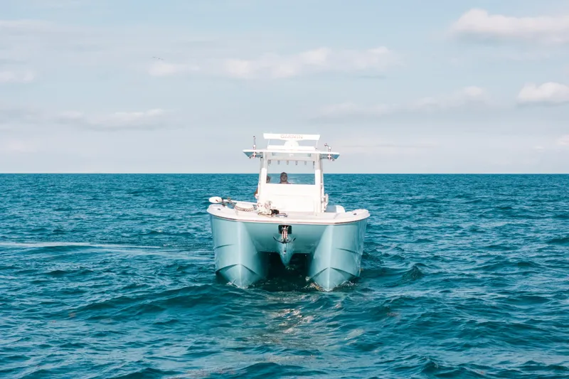  Yacht Photos Pics Invincible 37 Catamaran 2021 cruising on open ocean under clear sky.