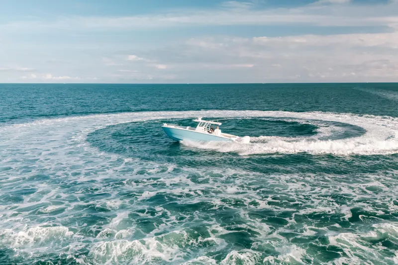  Yacht Photos Pics Invincible 37 Catamaran 2021 making waves in open ocean, aerial view.