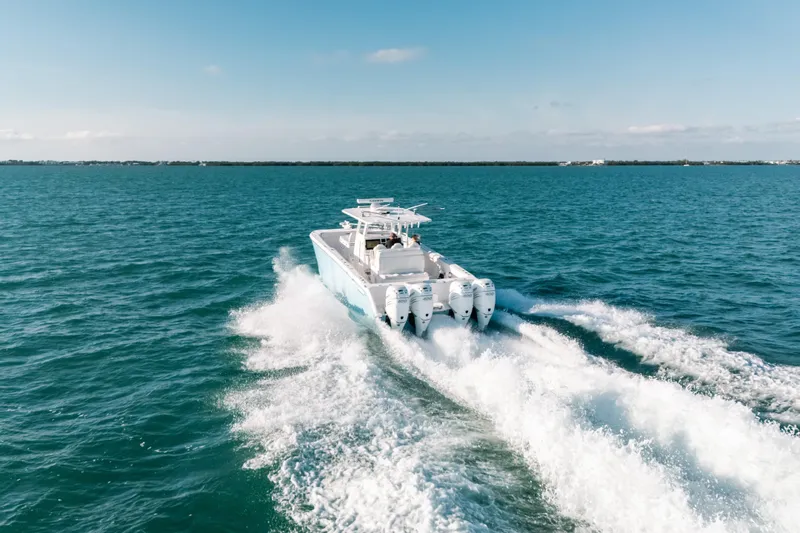  Yacht Photos Pics Invincible 37 Catamaran 2021 cruising on open sea, showcasing powerful engines and sleek design.