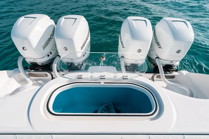  Yacht Photos Pics 2021 Invincible 37 Catamaran with four Mercury outboard engines on blue water.